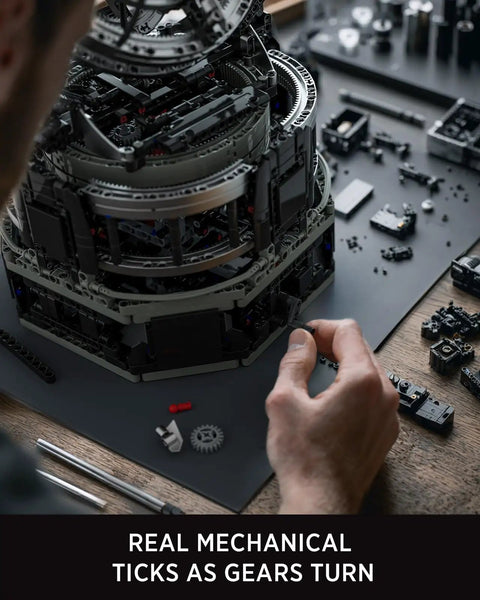Person assembling Tourbillon Engineering Building Set For Adults, advanced hand crank mechanical display with moving gears.