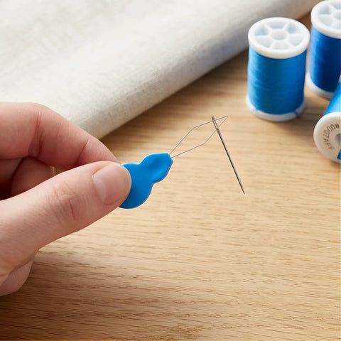 Hand holding Gourd Shape Needle Threader For Embroidery And Sewing Machines Ultra Portable Handheld Tool With Plastic And Metal Build For Effortless Hand Sewing And Machine Threading Grab And Go Travel Companion, threading a needle
