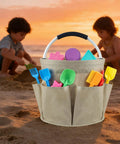 17L Foldable Cleaning Caddy With Handle And Six Pockets at the beach with toys, sunset backdrop, durable Oxford cloth tote