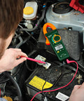 Technician using 400A True RMS AC Clamp Meter with Non Contact Voltage Detection, 1.2 Inch Jaw on car battery