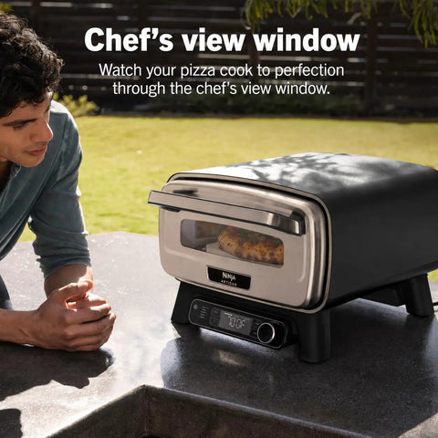 Backyard Pizza Oven With Stone 12 Inch Ready In Just 3 Minutes For Artisan Crusts With 700F Max Temperature Five In One Functionality Bake Broil Proof And Warm Makes Full Family Meals Outdoors For Your Cookout Gray MO201 on patio counter with chef's view window.