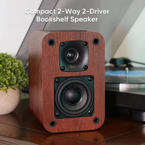 Powered Bluetooth Bookshelf Speakers With 40W Output, 2.75-Inch Woofer, showing front view on wooden cabinet.