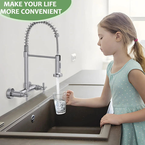 Rock Solid Wall Mount Kitchen Faucet With Smooth Dual Handles And No Fuss Two Function Spray For Laundry Or Commercial Sinks Built Tough From Lead Free Brushed Nickel Stainless Steel being used to fill a glass with water.