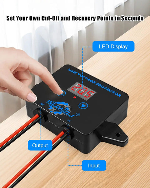 Person adjusting Beefed-Up 12V To 36V DC Low Voltage Protection Module with Display on a wooden table.