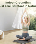 Woman meditating on Easy At Home Indoor Grounding Kit with two mats for wellness and balance