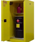 Built Tough Yellow Flammable Drum Storage Cabinet Holds 60 Gallons with a black drum and shelf inside, designed for hazardous materials.