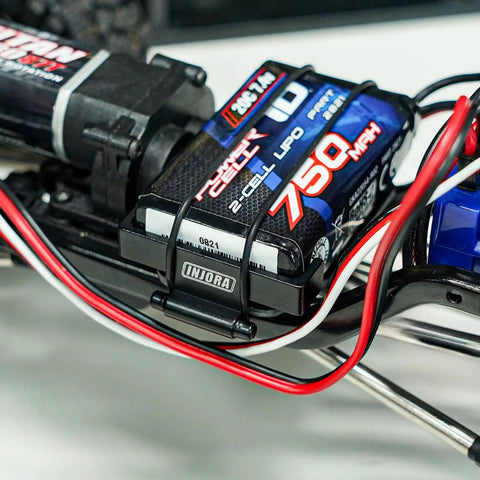 Close-up of 39g LCG Carbon Fiber Chassis Frame Kit with 6g Battery Tray mounted on 1/18 TRX4M RC Crawler, showing wiring details.