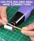 Using 100Pcs Heat Shrink Solder Seal Wire Connectors with heat gun on green cutting mat for wiring repair.