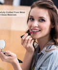 Woman applying lipstick using a telescoping inspection mirror, crafted from metal and glass, focus on product use