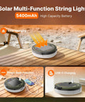 Solar Camping String Lights With Built In 5400mAh Power Bank USB Charger shown charging on a wooden table outdoors