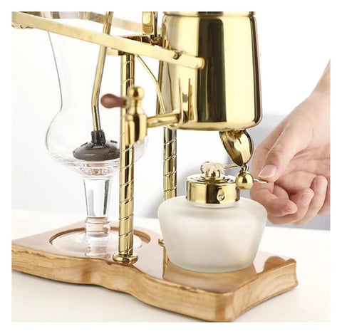 Top Shelf Siphon Coffee Maker Syphon Glass Brewer 4 Cup with gold finish and ergonomic handle in use for smooth brewing.