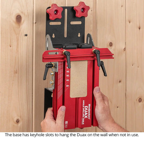 Dual Axis Angle Drilling Guide With Adjustable Fence and Clamp Table USA Made Drill Press Jig mounted on a wall for storage