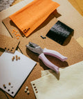 Purple Circle Hand Punch 1/4 Inch For Crafts With Cushioned Grip on craft paper, used for scrapbooking and card making.