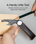 Ultra Slim Stainless Steel Multi Tool V2 With Titanium Coating Pocket EDC Gear for package cutting on wooden surface.