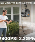 Person using Retractable Wall Mount Pressure Washer Pro Electric Power Cleaner With 2900 PSI 2.2 GPM 100 Ft Hose on house siding.