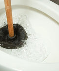 Heavy Duty Rubber Toilet Plunger With Solid Wood Handle And Precision Force Cup Head Boosts Suction To Clear Toilets Sinks And Drains Fast Classic Design That Nixes Stubborn Clogs And Gunk Instantly in action in a toilet bowl.
