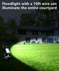 6000 Lumen LED Work Light With Stand Waterproof Flood Light 60W illuminating a courtyard at night, showcasing its brightness.