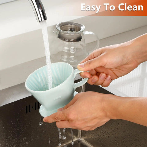 Person cleaning Travel Ready Ceramic Pour Over Coffee Dripper With Three Hole Flat Bottom Cone For On The Go Brewing, No Fuss Handmade Ceramic Brew Tool For Travel Camping Office Or Home Green under running water at kitchen sink.