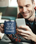 Man holding phone with 14oz vacuum insulated stainless steel coffee mug for men with the message You Are Awesome