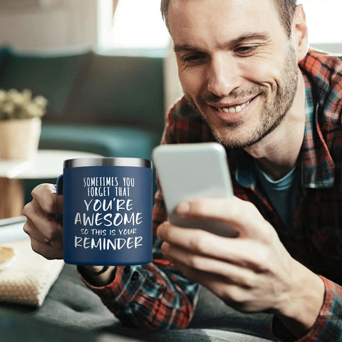 Man holding phone with 14oz vacuum insulated stainless steel coffee mug for men with the message You Are Awesome