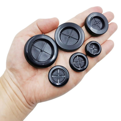 Hand holding DIY Ready All In One Rubber Grommet Kit For Wiring With 51 Black Grommets In Six Hole Sizes Five Eighths Inch To One And A Half Inch