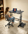 Smooth Operator Height Adjustable Standing Desk With Heavy Duty Steel Build And Six Easy Roll Wheels For Ergonomic Sit Stand Office Setup To Level Up Your Grind, female user at desk.