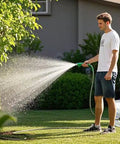 Person using 50 Gallon Collapsible Water Storage Bladder With Spigot For Emergency Prep in garden