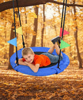 Child enjoying 24 Inch Saucer Tree Swing For Kids And Adults Heavy Duty 220Lb in fall setting, blue 900D Oxford seat