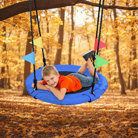 Child enjoying 24 Inch Saucer Tree Swing For Kids And Adults Heavy Duty 220Lb in fall setting, blue 900D Oxford seat