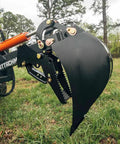 Skid Steer Fronthoe Attachment With 14 Inch Bucket And Bolt On Backhoe Thumb For Universal Quick Attach, side view in field