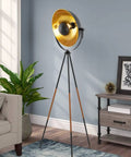 Lit Modern Tripod Floor Lamp in Black Finish with Gold Foil Circular Shade and Leather Accented Legs, 58 Inch Tall in living room