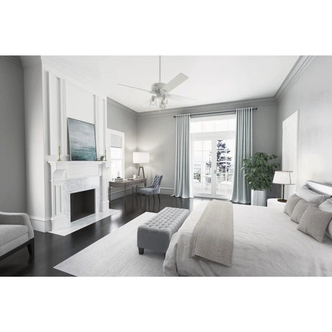 Modern 52 Inch Matte White Ceiling Fan With LED Light And Pull Chain Multi Speed WhisperWind Motor in a stylish bedroom setting
