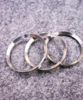 Waterjet pump intensifier back rings, three silver stainless steel rings (front view).
