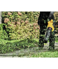 Person using 60V Max FlexVolt Cordless Handheld Leaf Blower 125 MPH Air Speed 600 CFM Airflow Tool Only in garden