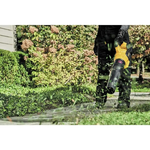 Person using 60V Max FlexVolt Cordless Handheld Leaf Blower 125 MPH Air Speed 600 CFM Airflow Tool Only in garden