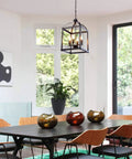 Industrial Pendant Light With Classic Black Metal Cage For Farmhouse And Modern Homes hanging above dining table.