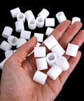 Hand holding white Universal Rubber Door Stopper Tips And Caps Replacement Set 40 Pcs for home or office use.