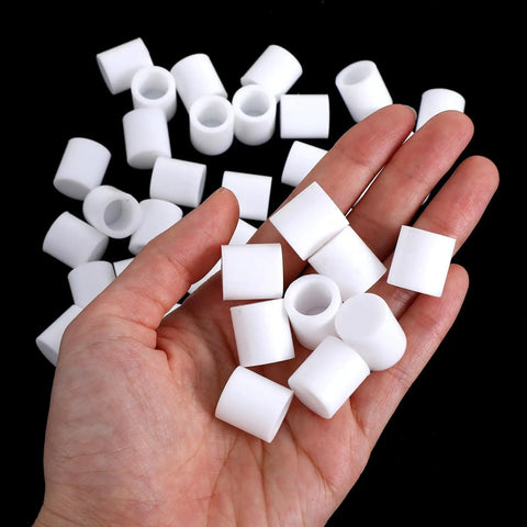 Hand holding white Universal Rubber Door Stopper Tips And Caps Replacement Set 40 Pcs for home or office use.