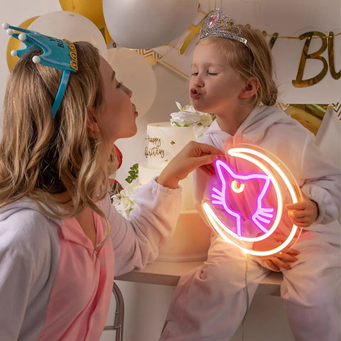 Two children in costumes holding Anime Luna Neon Sign LED Dimmable Moon Cat Night Light For Bedroom Wall Decor Lit Pink Kawaii Neon Light