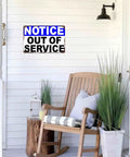 Notice Out Of Service Metal Sign 8x12 Inch Funny Aluminum Wall Decor for office and workplace; sign on white wall with decor.