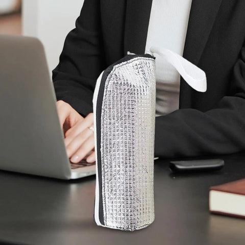 Insulated Bottle Cooler Bag and Thermal Tote with Triple Layer Insulation on desk, silvery exterior for moisture blocking.