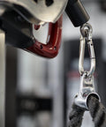 Close-up of a 3.5-inch silver metal carabiner clipped to rope, showing a spring-loaded gate.