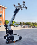 Heavy Duty Electric Suction Cup Lifter Moves Sheet Glass Without The Sweat For Easy Load Out During Commercial Curtain Wall Installations And Job Site Projects, shown in outdoor setting with raised arm.