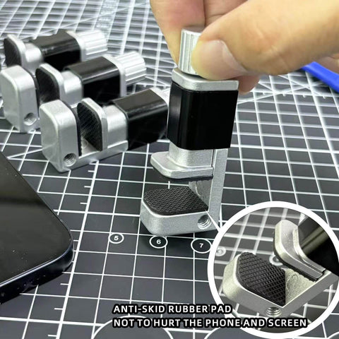 Adjustable Screen Repair Clamps Kit For Phones And Tablets with rubber pads on cutting mat, holding screens firmly during replacement.