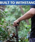 Person using Rugged Tactical Hiking Stick With Built-In Multi-Tool, 8-Section Walking Staff Made From Aerospace-Grade 6061-T6 Aluminum