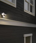 3 Light LED Outdoor Flood Lights With Dusk To Dawn Sensor Adjustable Brightness mounted on dark house exterior at dusk