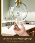 Close-up of Two Pack Slick Vintage Pendant Lights With Clear Glass Globes And Gleaming Gold Canopies Adjustable Drop Length design for easy bulb replacement.