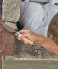 Person using Pointing Trowel 7 Inch By 3 Inch With Wooden Handle For Masonry Cement And Concrete Finishing Pro Quality For DIY Projects