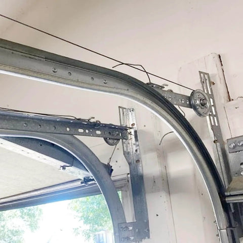 Close-up of installed Built To Last 1.5mm Steel R12 Horizontal Garage Door Tracks for 7 Foot Doors 2 Inch Rail Pair