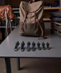 6 Piece Zipper Restoration Kit With Metal Sliders And Teeth displayed on table with jacket and backpack in background